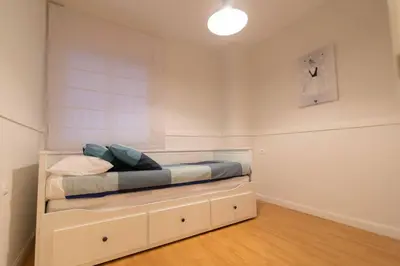 a bedroom with a bed with a built in cabinet at Alquileres Kakiko in Sanlúcar de Barrameda