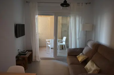a living room with a couch and a table at Apartamento Playa Victoria - Cádiz in Cádiz