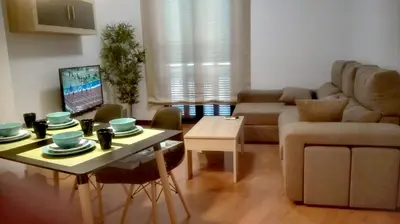 a living room with a table and a couch at Apartamento Santa Faz in El Puerto de Santa María