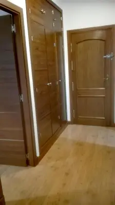 an empty room with wooden doors and wooden floors at Apartamento Santa Faz in El Puerto de Santa María