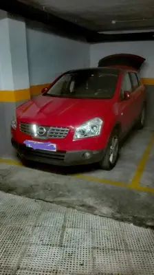 a red car parked in a parking garage at Apartamento Santa Faz in El Puerto de Santa María