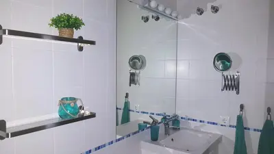 a white bathroom with a sink and a mirror at Sherryflat Paralejo 10 - Parking in Jerez de la Frontera