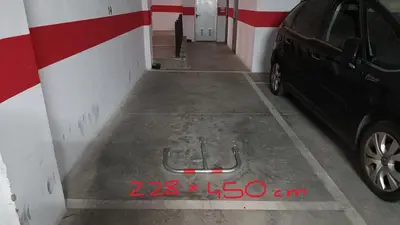 a parking garage with a car parked in it at Sherryflat Paralejo 10 - Parking in Jerez de la Frontera