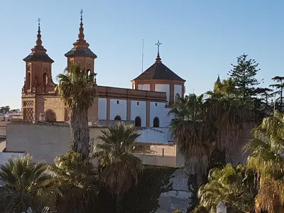 a church with two towers and palm trees in front of it at Sherryflat Paralejo 10 - Parking in Jerez de la Frontera