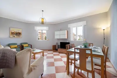 a living room with a table and a dining room at Grand Beachside Apartment - Cádiz in Cádiz