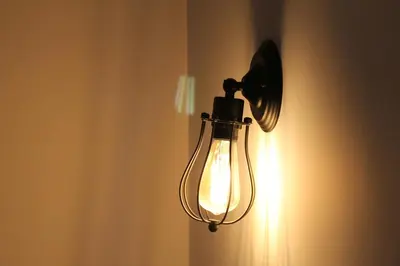 a light on a wall with a light on it at Hospederia 1881 in Chiclana de la Frontera