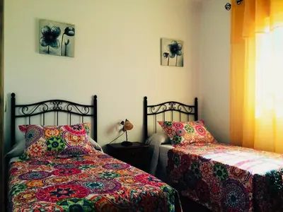 a bedroom with two beds and a window at Villa Gallardo - Cerca Playa y Pueblo in Conil de la Frontera
