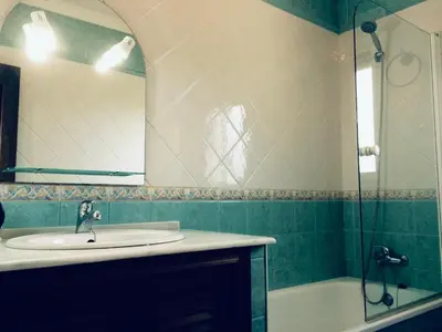 a bathroom with a sink and a mirror and a tub at Villa Gallardo - Cerca Playa y Pueblo in Conil de la Frontera