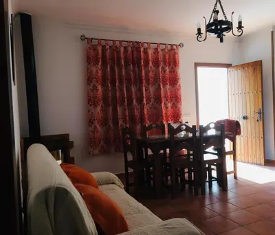a living room with a couch and a table at Villa Gallardo - Cerca Playa y Pueblo in Conil de la Frontera