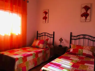 a bedroom with two beds and a window at Villa Gallardo - Cerca Playa y Pueblo in Conil de la Frontera