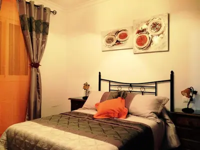 a bedroom with a bed with two plates on the wall at Villa Gallardo - Cerca Playa y Pueblo in Conil de la Frontera