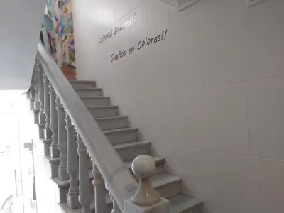 a staircase in a building with a sign on the wall at Hotel Sur Utopia in El Puerto de Santa María