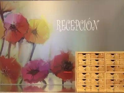 a room with a painting of flowers on the wall at Hotel Sur Utopia in El Puerto de Santa María