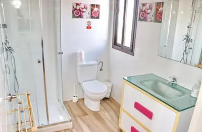 a bathroom with a toilet and a shower and a sink at Bungalow Ramos II in Conil de la Frontera