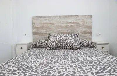 a bedroom with a large bed with two pillows at Chalet Lobita in Conil de la Frontera