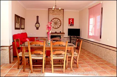 a dining room with a table and chairs at Chalet Puente de Tabla in Conil de la Frontera