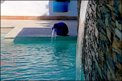 a fire hydrant in the middle of a pool of water at Bungalow La Roa IV in Conil de la Frontera
