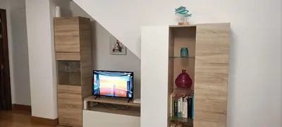 a living room with a television in a stair case at Apartamento Aldama en el centro de Sanlúcar de Barrameda in Sanlúcar de Barrameda