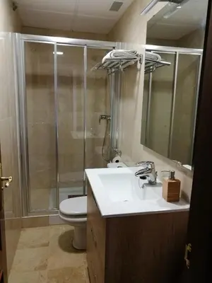 a bathroom with a shower and a sink and a toilet at Apartamento Aldama en el centro de Sanlúcar de Barrameda in Sanlúcar de Barrameda