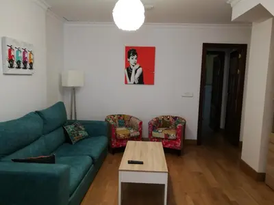 a living room with a couch and a table at Apartamento Aldama en el centro de Sanlúcar de Barrameda in Sanlúcar de Barrameda