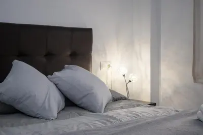 a bed with two pillows on it in a bedroom at Apartamento ateneo in Sanlúcar de Barrameda