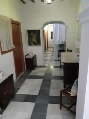 a living room with a black and white checkered floor at Hostal Centro Sol in Cádiz