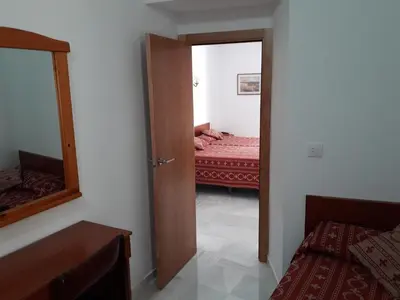 a room with a mirror and a bedroom with a bed at Hostal Centro Sol in Cádiz