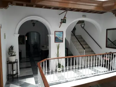 a staircase in a house with white walls and floors at Hostal Centro Sol in Cádiz