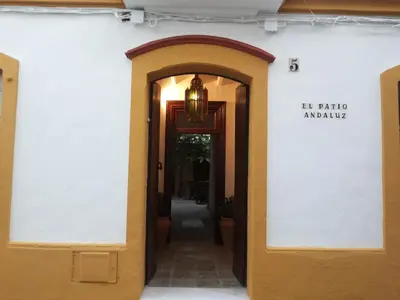an open door to a building with a chandelier at Apartamentos El Patio Andaluz in Jerez de la Frontera