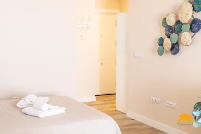 a bedroom with a bed with towels on it at Apartamentos Ancha 22 by Cadiz Time in Cádiz
