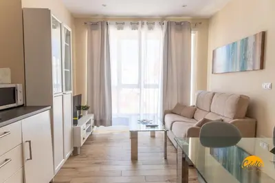 a living room with a couch and a glass table at Apartamentos Ancha 22 by Cadiz Time in Cádiz