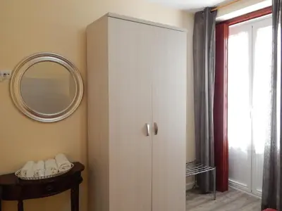 a white cabinet in a room with a mirror at Hospederia Marqués in Cádiz
