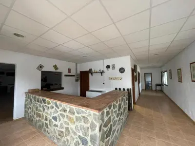 a room with a counter in a room with a refrigerator at Alojamiento Rural - Finca Santa Margarita in Algar