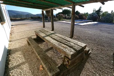 a wooden bench sitting under a pavilion at Alojamiento Rural - Finca Santa Margarita in Algar
