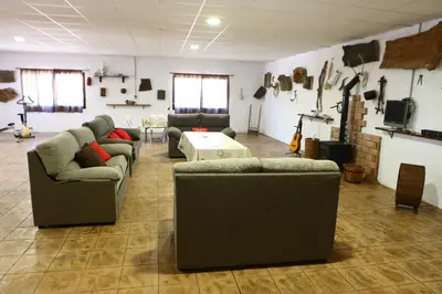 a living room with two couches and a table at Alojamiento Rural - Finca Santa Margarita in Algar