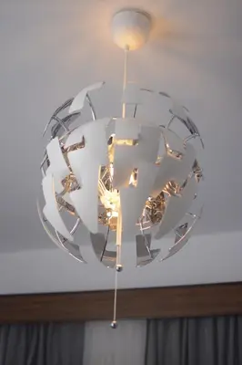 a circular light fixture hanging from a ceiling at San Francisco's House in Medina Sidonia