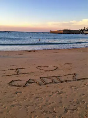 an inscription written in the sand on a beach at Casa Caracol in Cádiz