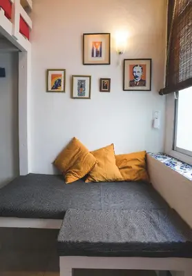 a bed in the corner of a room at Casa Caracol in Cádiz