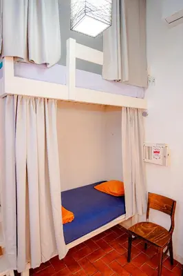 a bunk bed with a chair in a room at Casa Caracol in Cádiz