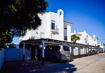 a van parked in front of a white building at Apartamento Barrosaplaya1 in Chiclana de la Frontera