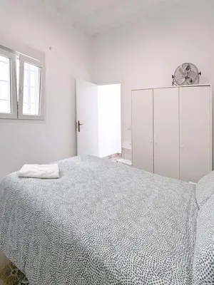 a bedroom with a large bed and a white cabinet at Gran Teatro Falla in Cádiz