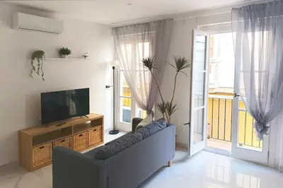 a living room with a couch and a flat screen tv at Gran Teatro Falla in Cádiz