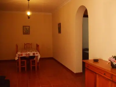 a dining room with a table and chairs in a room at Apartamentos Las Parcelas in Conil de la Frontera