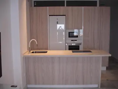 a kitchen with a counter with a sink and a microwave at Kiana Mirador Puerto Sherry con parking in El Puerto de Santa María