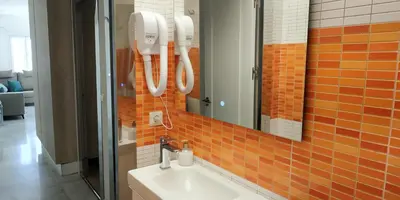 a bathroom with a sink and a mirror at Kiana Mirador Puerto Sherry con parking in El Puerto de Santa María