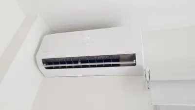 a white microwave oven sitting on a white wall at Kiana Mirador Puerto Sherry con parking in El Puerto de Santa María
