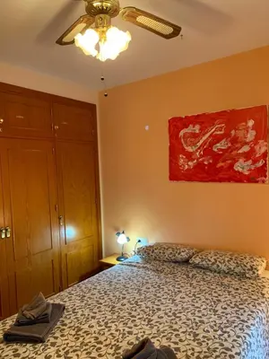 a bedroom with a bed and a ceiling fan at Traumhaus für 6 Personen mit spektakulärem privaten Pool und schönem Ausblick in die Natur in Hozanejos