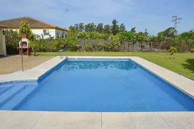 a large blue swimming pool in a yard at Traumhaus für 6 Personen mit spektakulärem privaten Pool und schönem Ausblick in die Natur in Hozanejos