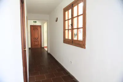 a hallway with a door and a window on a wall at Hotel El Coloso in Jerez de la Frontera