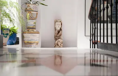 a table with two vases and a statue on it at Casa Patio del Panadero in Cádiz